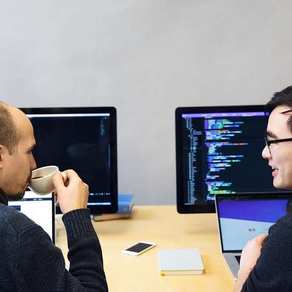 Developers discussing javascript code 925x